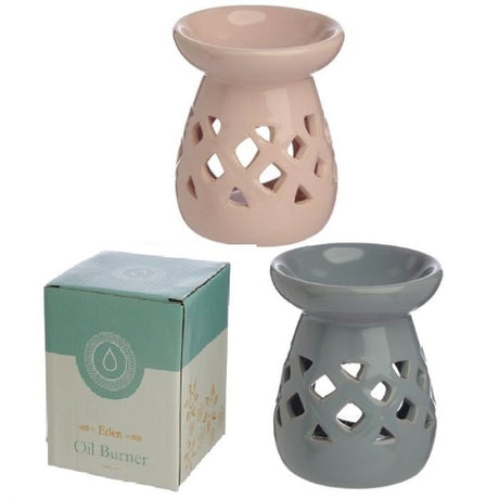 Ceramic oil and wax burners with cut-out lattice design; set of 2 in pastel colors for cozy ambiance and scent personalization.