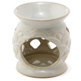 Elegant ceramic oil burners in assorted designs, featuring scallop cut-outs for beautiful ambient lighting and scent diffusion.