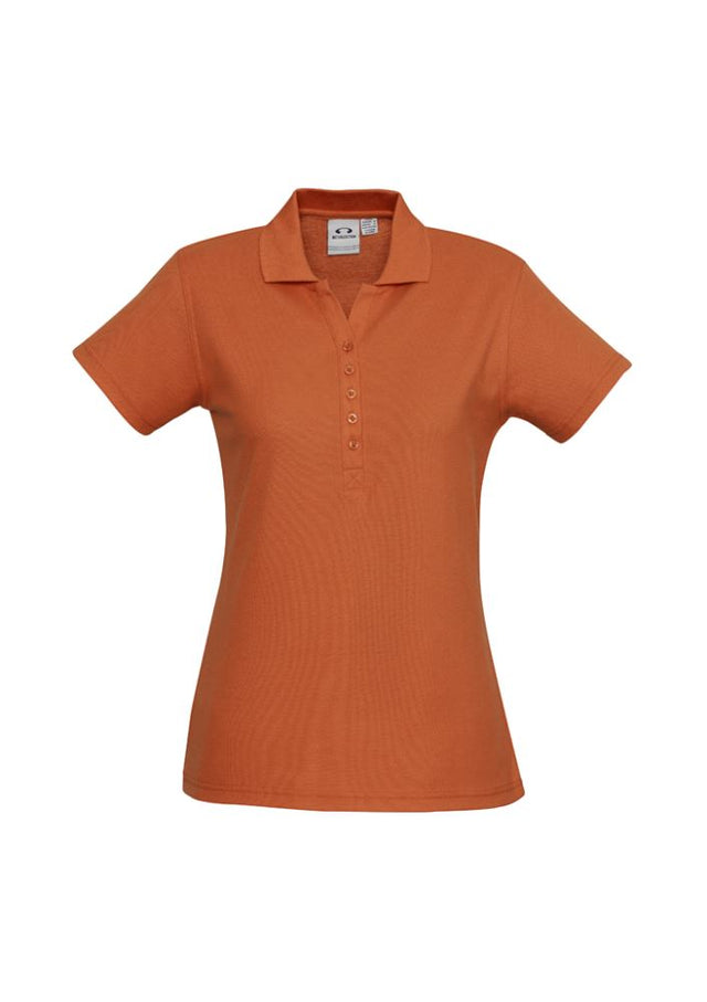 Ladies Crew Polo in vibrant orange, size 10, features a stylish Y-placket, knitted collar, and durable stitching for comfort and elegance.