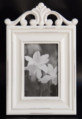 Elegant white photo frame with intricate carvings, perfect for showcasing cherished memories in any decor style.