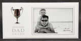 Elegant photo frame with a silver trophy, celebrating dad's achievements and cherished memories in stylish decor.
