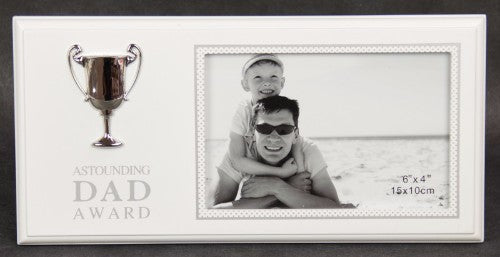 Elegant photo frame with a silver trophy, celebrating dad's achievements and cherished memories in stylish decor.