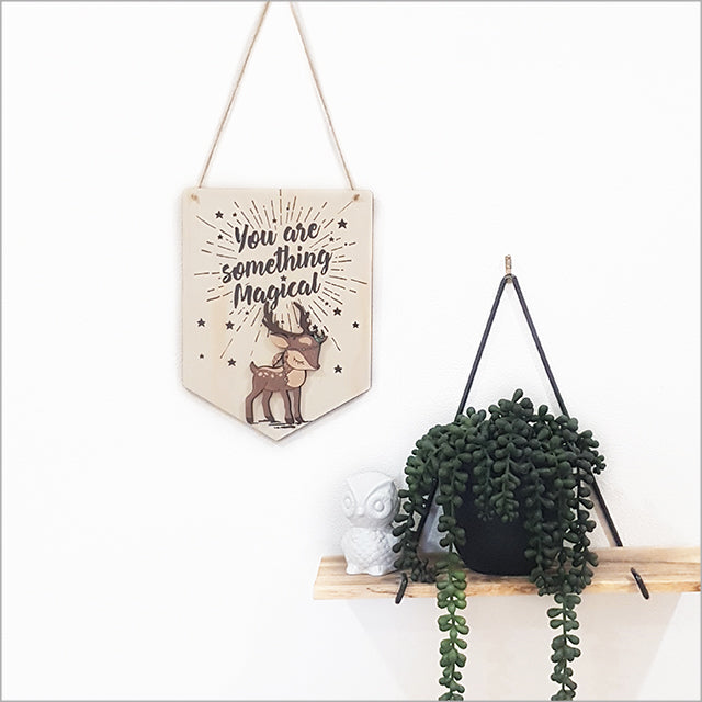 Wall art featuring a whimsical printed pine flag, perfect for children's rooms and creative spaces.