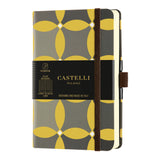 Elegant Castelli Oro Notebook with textured geometric design, ruled ivory pages, and gold ribbon marker for organized note-taking.