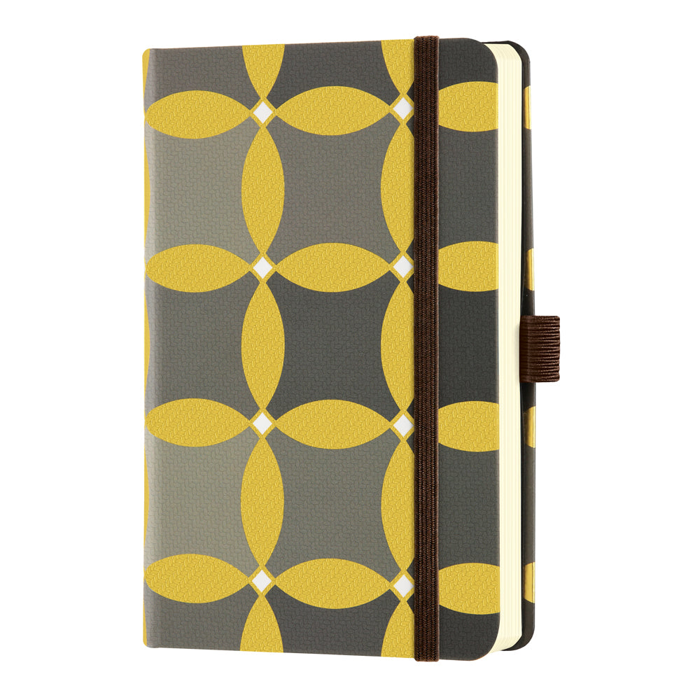 Elegant Castelli Oro notebook with textured weave, geometric designs, ruled pages, gold ribbon marker, and eco-friendly features.