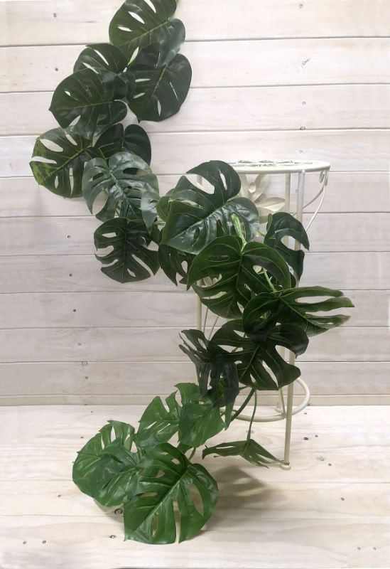 Lush 1.8m Monsteria Leaf Garland in vibrant green, perfect for tropical decor and versatile for any occasion.