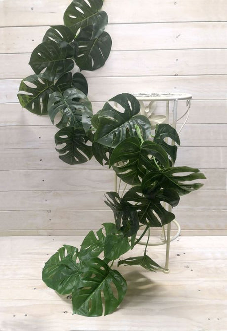 Lush 1.8m Monsteria Leaf Garland in vibrant green, perfect for tropical decor and versatile for any occasion.