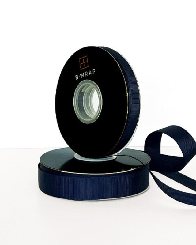 Navy grosgrain ribbon, 13mm wide and 30m long, perfect for elegant crafting and DIY projects. Ideal for embellishments and gift wrapping.