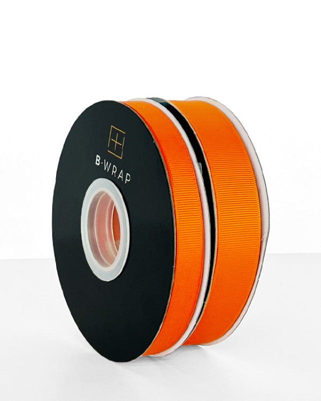 Vibrant orange grosgrain ribbon, 22mm wide and 30m long, perfect for crafting, gift wrapping, and decorating.