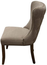 Elegant grey linen dining chair with a buttoned back and solid oak legs, perfect for adding luxury to any dining space.