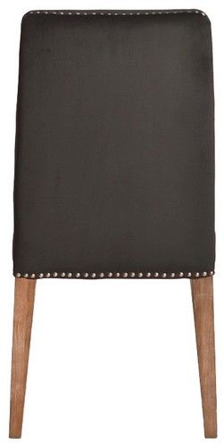 Dark grey velvet dining chair with antique studs, solid timber frame, blending modern luxury with classic elegance.
