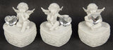 Set of 3 charming cherub figurines on heart-shaped bases, perfect for home decor and whimsical gifts.