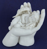 Handcrafted resin cherub ornament gently cradling a figure, embodying love and serenity for charming home decor.