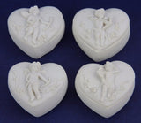 Set of 24 cherub-themed decorative ornaments, tealight holders, and oil burners in a heart-shaped box, perfect for home decor.