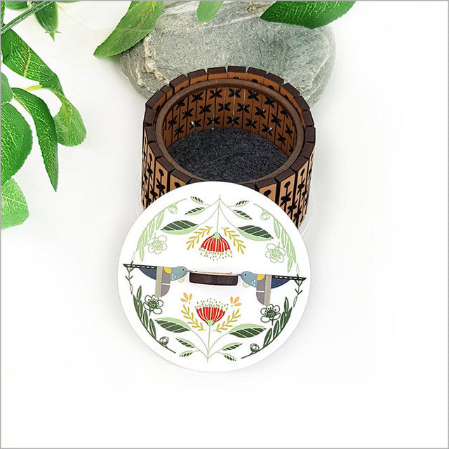 Round trinket box featuring folk tui design on acrylic lid, crafted from NZ rimu veneer with cork base for stylish storage.