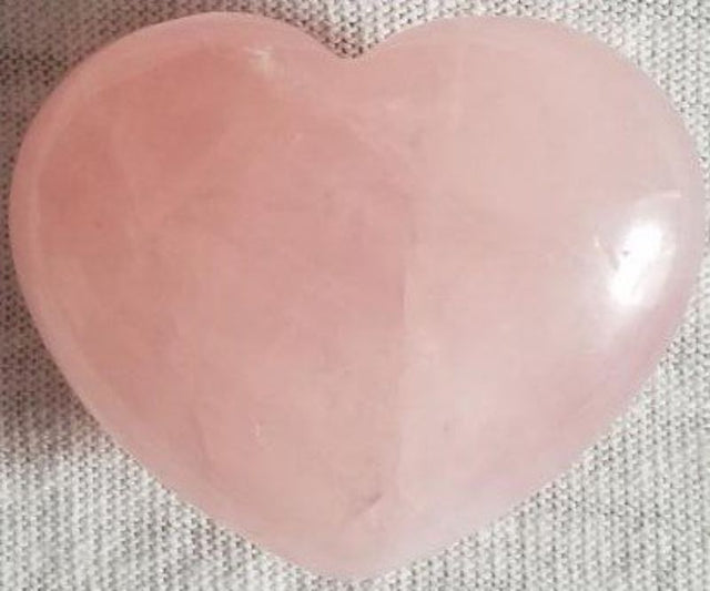 Rose quartz heart (3cm) radiating soft pink energy, symbolizing love and compassion, perfect for meditation or home decor.