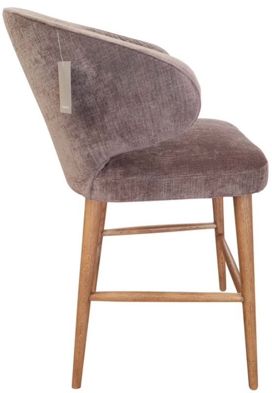 Stylish grey chenille barstool with a 65cm seat height, featuring romantic curves, brass legs, and a sturdy timber frame.