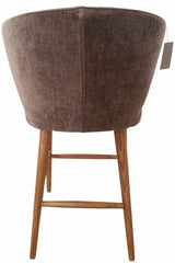 Stylish grey chenille barstool with romantic curves, 65cm seat height, sturdy timber frame, and elegant brass legs.