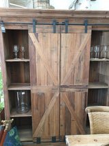 Rustic bar and wine unit with sliding doors, crafted from reclaimed pine and iron, perfect for stylish beverage storage.