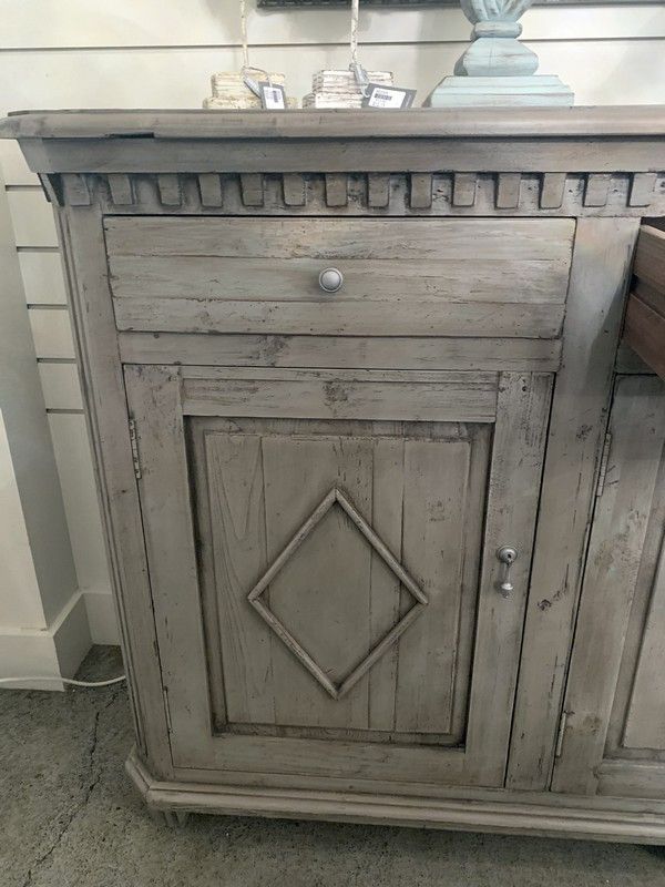 Distressed grey sideboard made from old pine, featuring three drawers and cupboards for stylish vintage storage.