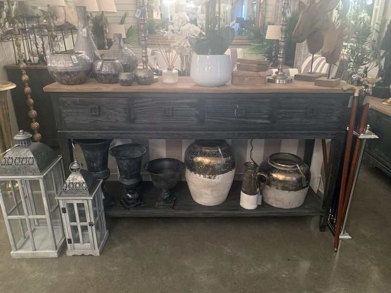 Elegant oak console with 4 drawers and a low shelf, blending vintage style and modern functionality for organized decor.