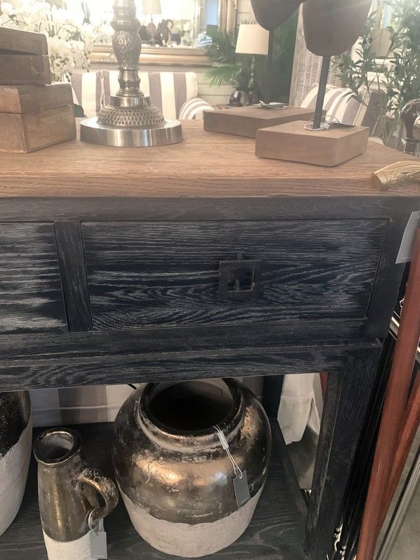 Elegant oak console with 4 drawers and a shelf, featuring a blend of light and dark wood, perfect for storage and decor.