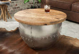 Stylish coffee table with a rounded solid wood top and sturdy metal base, perfect for industrial or rustic interiors.