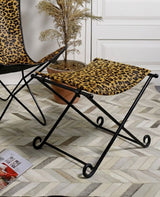 Handcrafted leopard print leather stool with sturdy iron frame, perfect as seating or accent piece in any home decor.