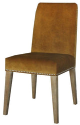 Dark mustard velvet dining chair with antique studs and solid timber frame, adding elegance and sophistication to dining spaces.
