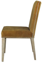 Elegant dark mustard velvet Pascal Dining Chair with antique studs, offering luxury and comfort for any dining space.