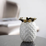 White ceramic pineapple vase, 13cm tall, adds tropical flair and sophistication to home decor or as a unique centerpiece.