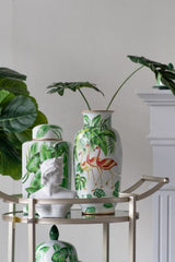 Illustrative porcelain vase featuring vibrant flamingos and lush leaves, ideal for fresh or dried floral displays.