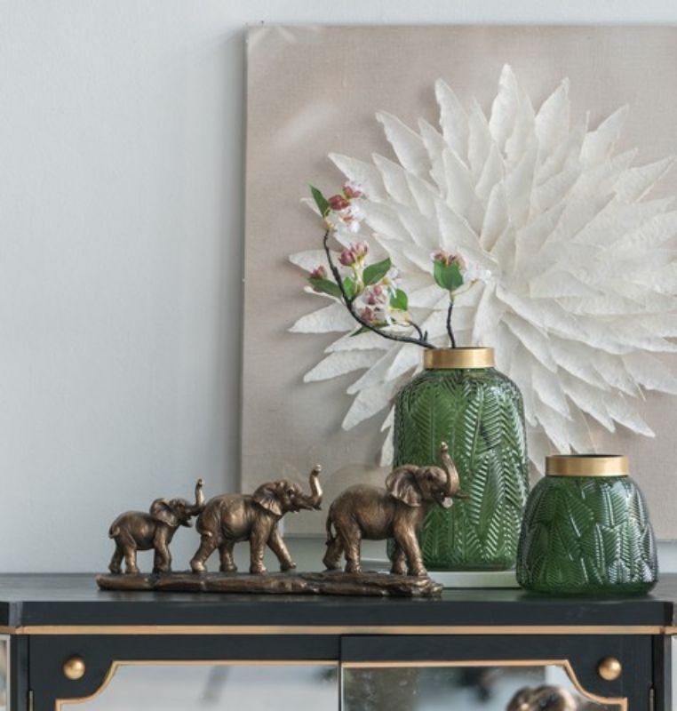 Elegant Elephant Family Statue featuring three intricately designed elephants, perfect for enhancing home decor.