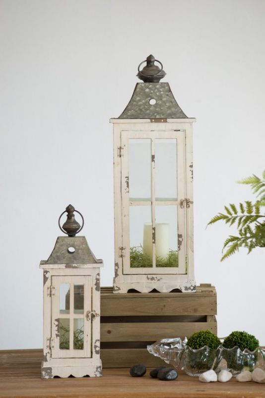 Set of 2 enclosed lanterns with handle, crafted from fir wood and glass for elegant indoor and outdoor illumination.