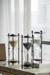 Elegant black hourglass with iron stand, perfect for home or office decor, measuring 15.8x15.8x33cm.