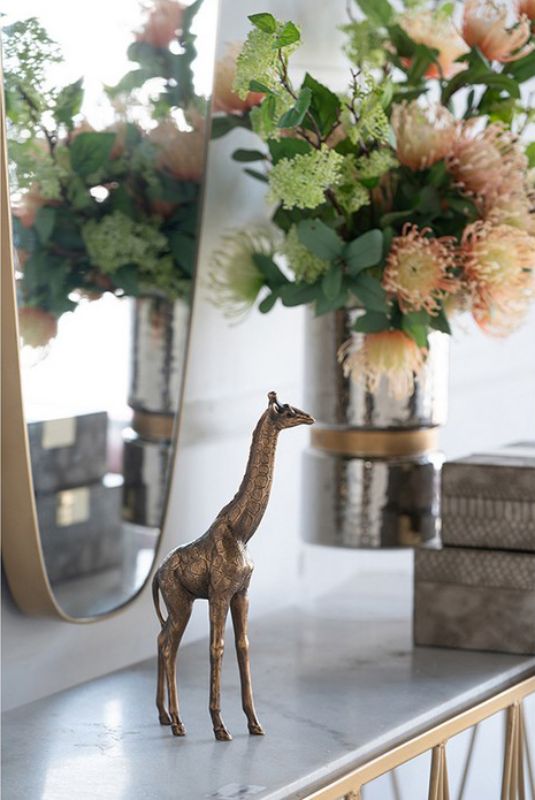 Whimsical 28.5cm giraffe ornament in copper finish, perfect for enhancing home decor and adding playful character.