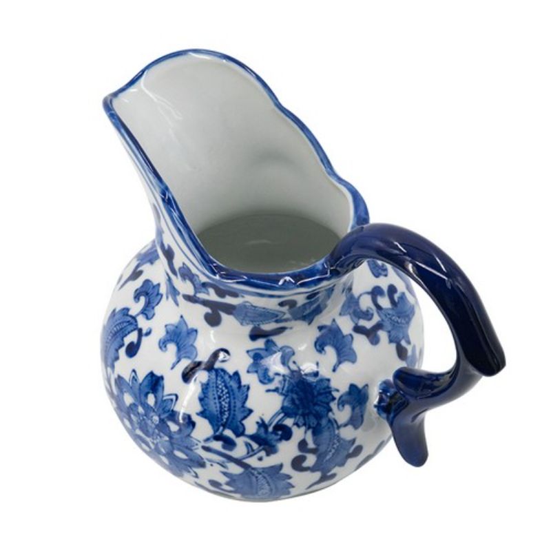 Charming blue and white porcelain milk jar with sculpted handle, perfect for traditional kitchen decor or flower display.