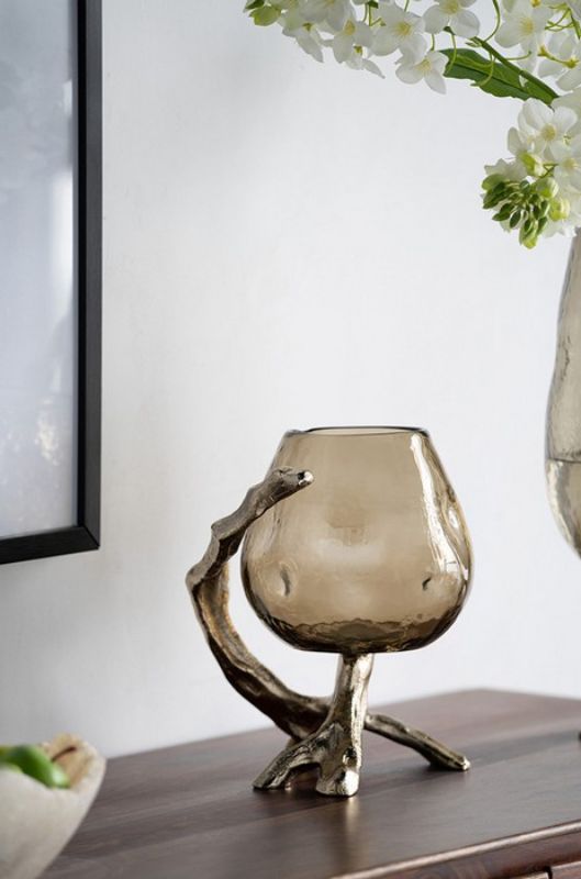 Stylish pillar candle holder with deep olive glass cup and gold accents, perfect for enhancing any table decor.