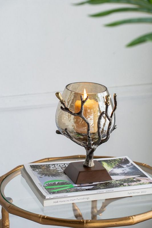 Antique nickel votive holder with gold accents, smoke glass shade, and walnut base for elegant home decor and cozy ambiance.