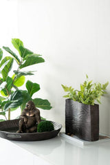 Large aluminum vase with a bright wenge finish and wavy design, perfect for elegant floral displays or modern decor.