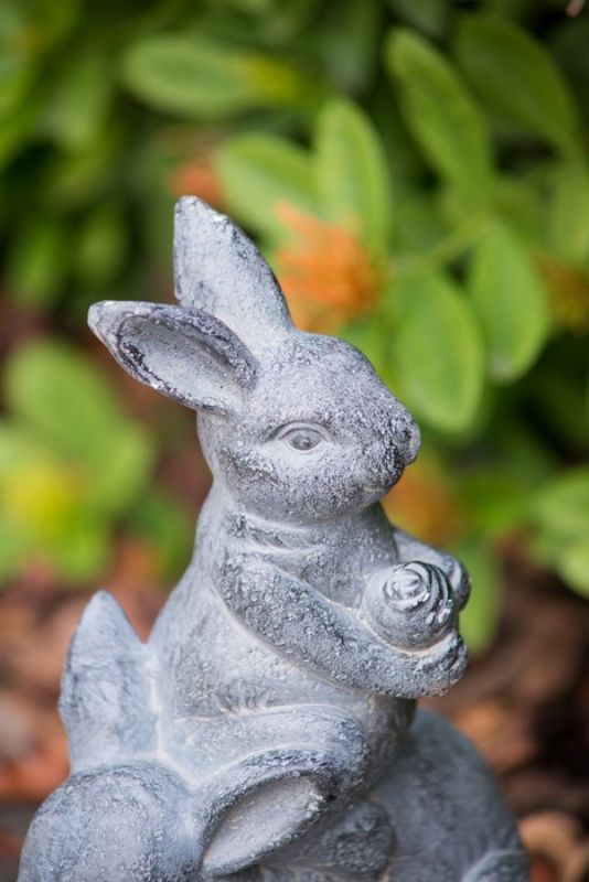 Charming rabbit family planter in neutral gray, ideal for showcasing blooms, herbs, or succulents indoors or outdoors.