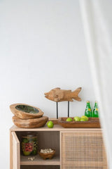 Handcrafted teak fish sculpture on stand, showcasing natural grain, perfect for adding rustic charm to modern decor.