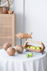 Handcrafted teak fish sculpture on stand, showcasing natural grain and rustic charm, ideal for modern home decor.