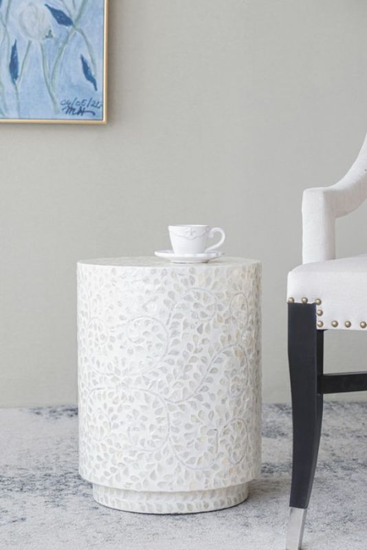 White accent stool/table featuring a sleek cylindrical design and capiz accents, perfect for stylish and practical home decor.