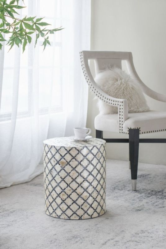 Accent stool/table with a chic black and cream diamond pattern, featuring elegant capiz inlay for versatile use.