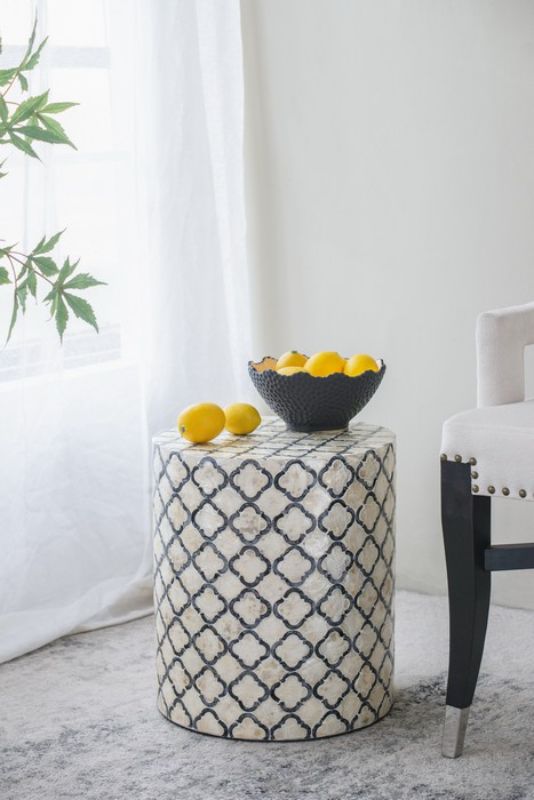 Accent stool/table with a black and cream diamond pattern, featuring capiz inlay for style and versatility in decor.