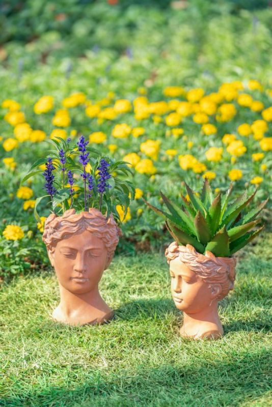 Terracotta visage head planter, 27cm tall, artfully designed for indoor/outdoor plants, adding rustic charm to any decor.