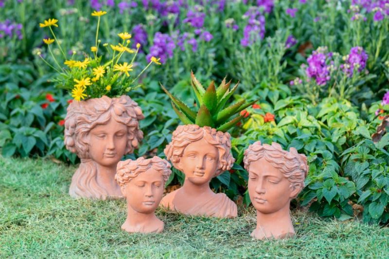 Terracotta Visage Head Planter, 24cm tall, features unique facial design for showcasing plants in a charming, artistic way.