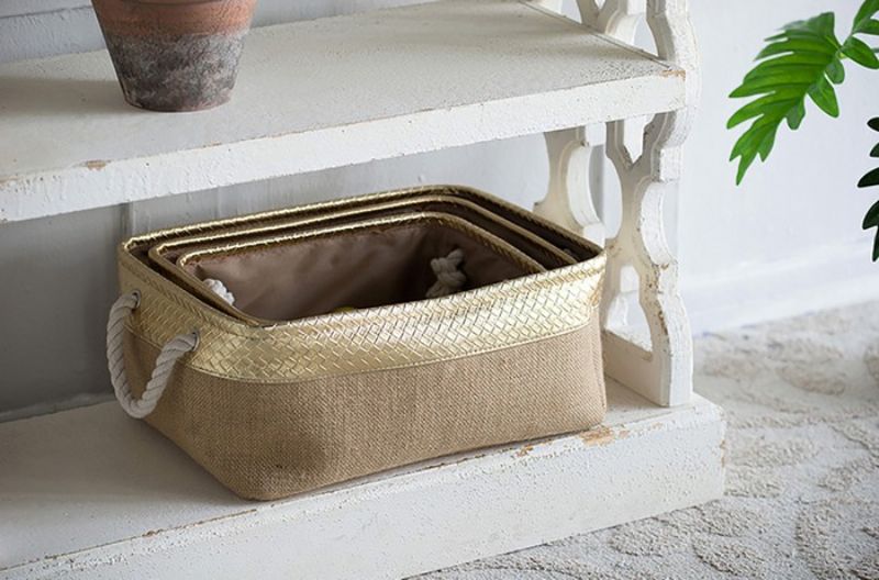 Stylish set of 3 eco-friendly jute baskets with gold faux leather, ergonomic handles, perfect for home organization.