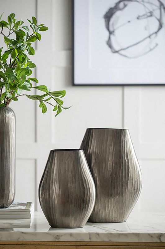 Tall aluminium vase with smoke chisel finish and vertical design, perfect for fresh flowers or as a stylish decor piece.